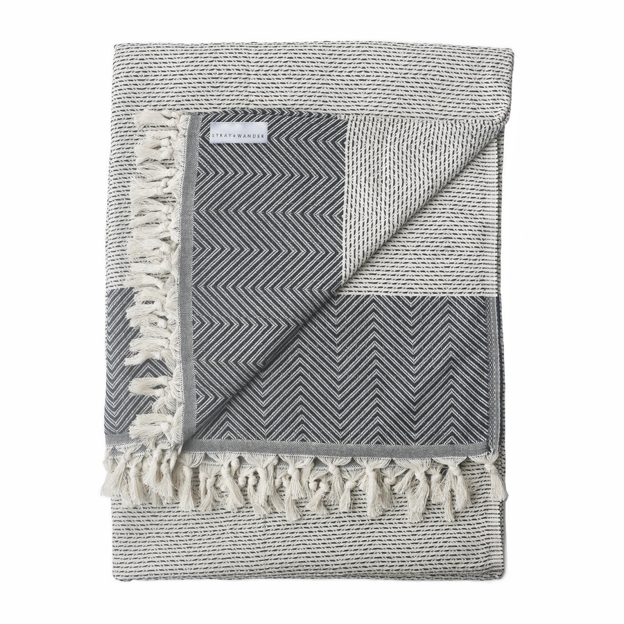 Beige Turkish Dream blanket folded with stripe and diamond shape patterns