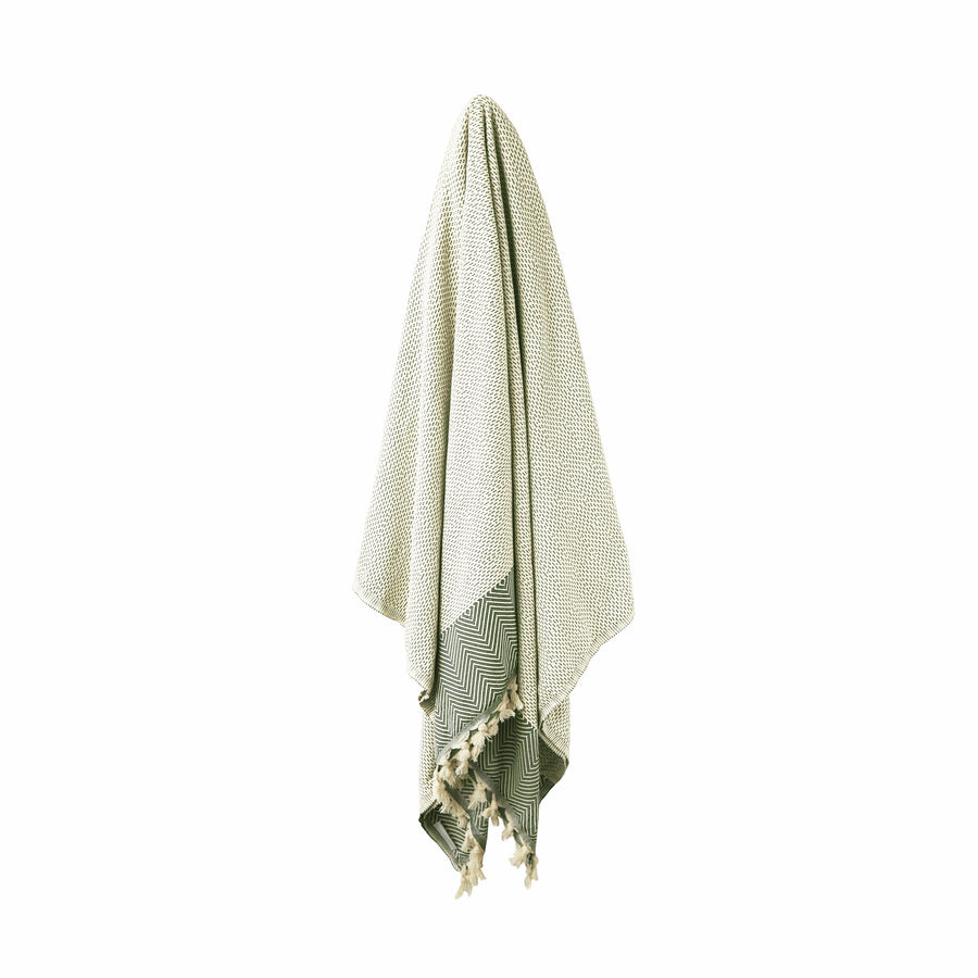 Beige and Green Turkish Dream blanket hanging with stripe and diamond shape patterns