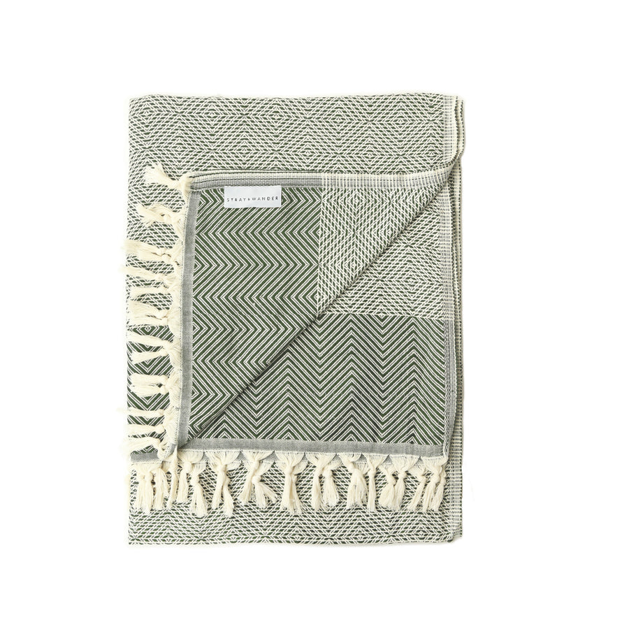 Green and Beige Turkish Dream blanket folded with stripe and diamond shape patterns